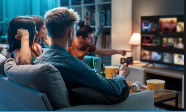 Friends choosing a movie to watch together at home, video on demand concept